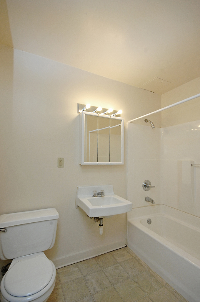 a bathroom with a toilet and a sink and a shower
