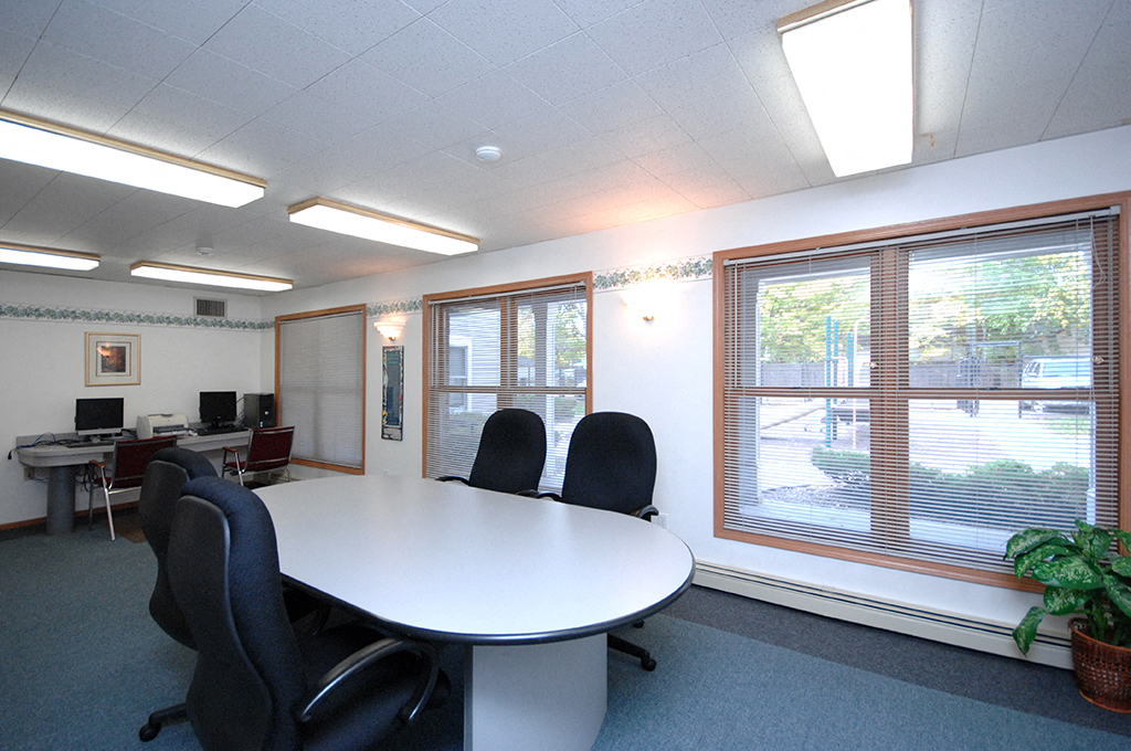 an office with a white table and chairs