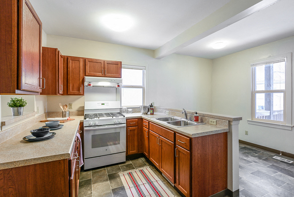 a kitchen with wooden cabinets and stainless steel appliances