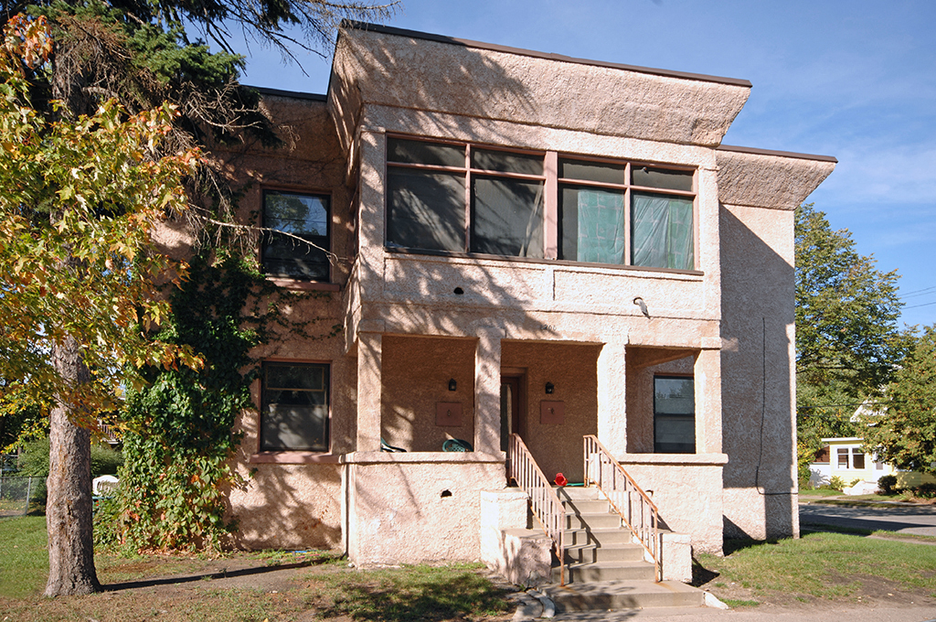 an old building with a tree in front of it