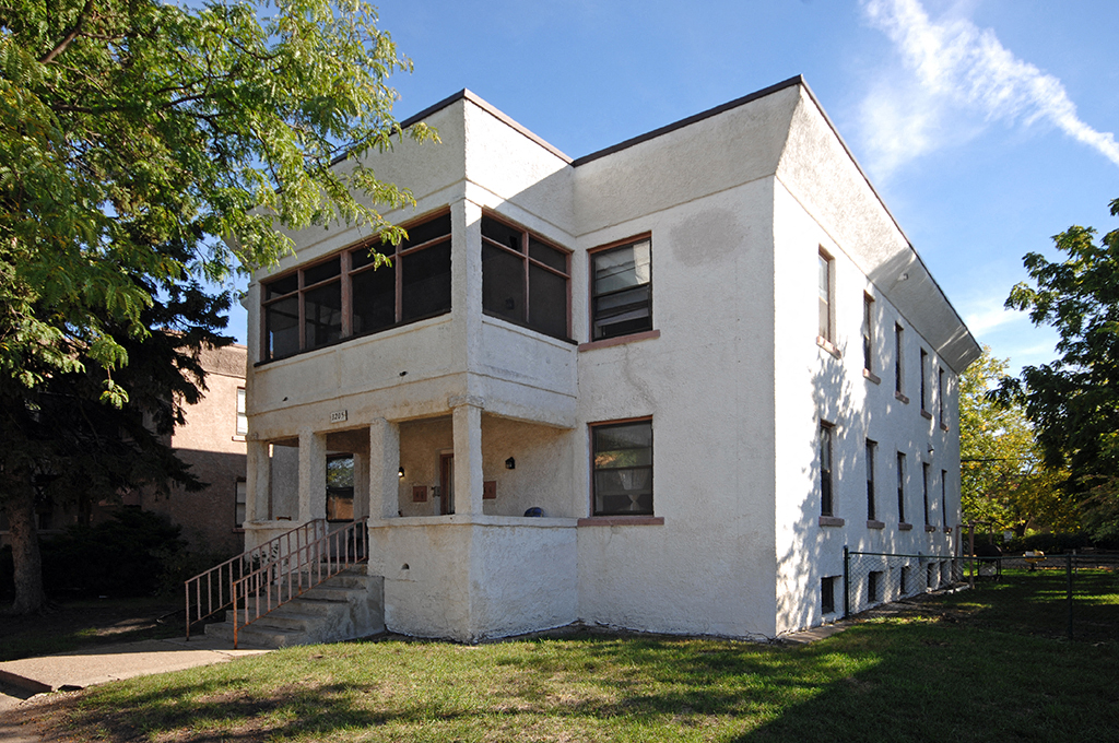 the exterior of a white house with windows and a staircase