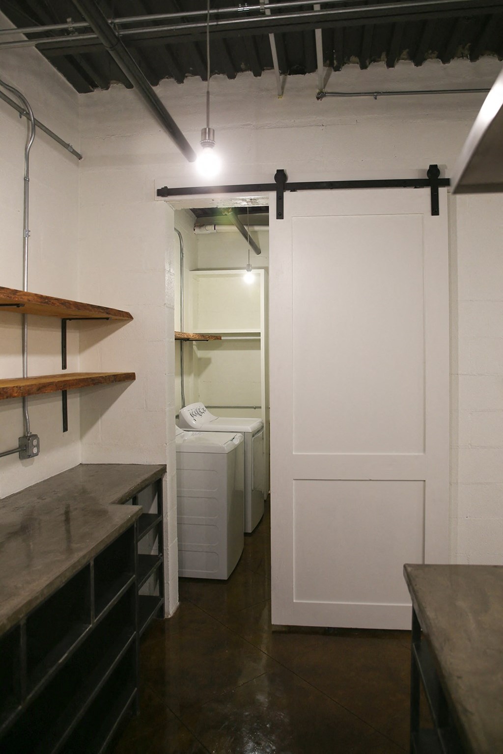 a small room with a white door and a washer and dryer in it