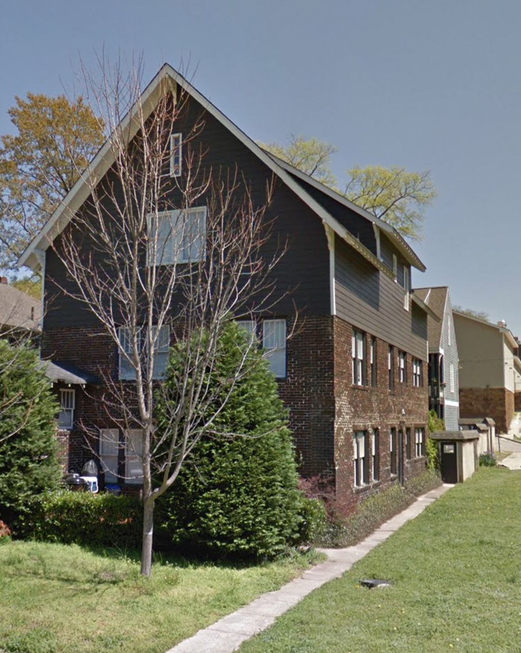 a house with a sidewalk in front of it