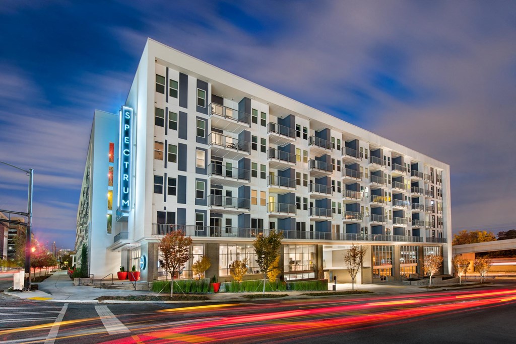 a rendering of a building on a city street at night