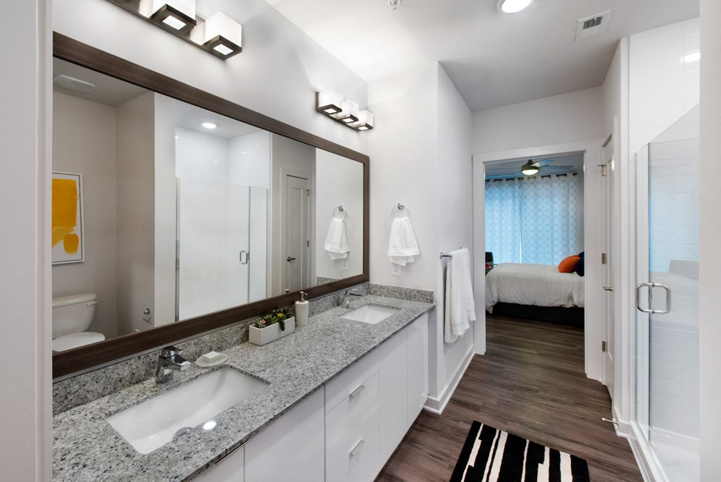 a bathroom with two sinks and a large mirror