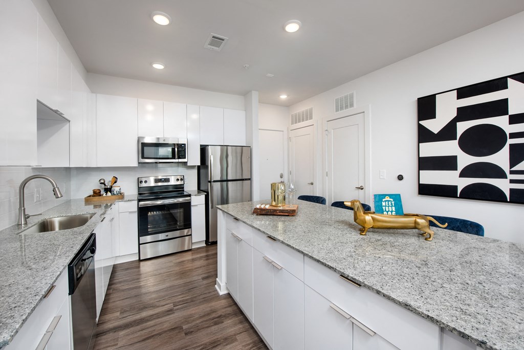 a kitchen with white cabinets and a counter top
