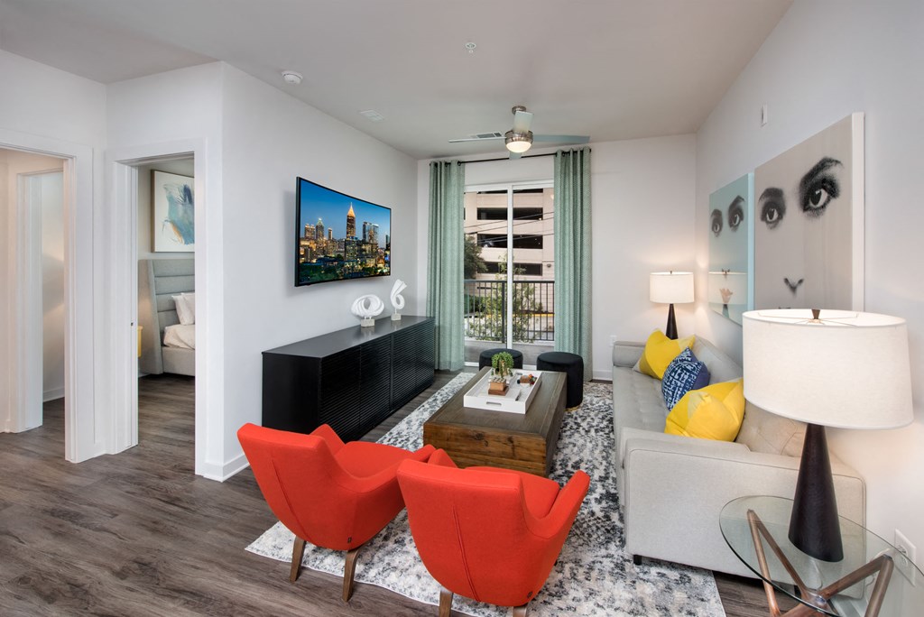 a living room with red chairs and a couch