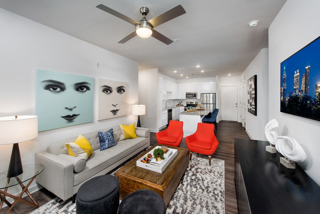 a living room with furniture and a ceiling fan