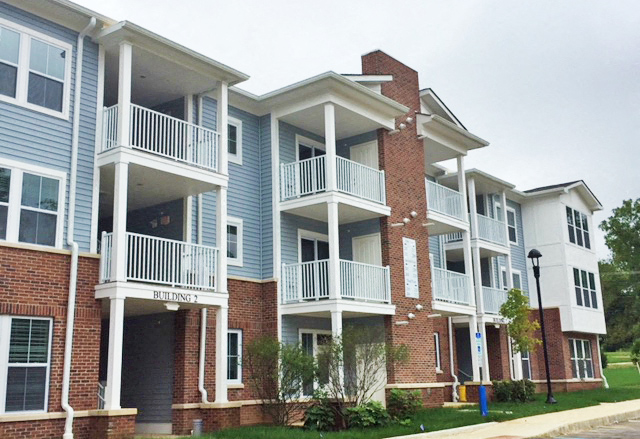 a row of apartment buildings with balconies and stairs