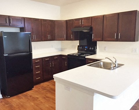 a kitchen with black appliances and white counter tops