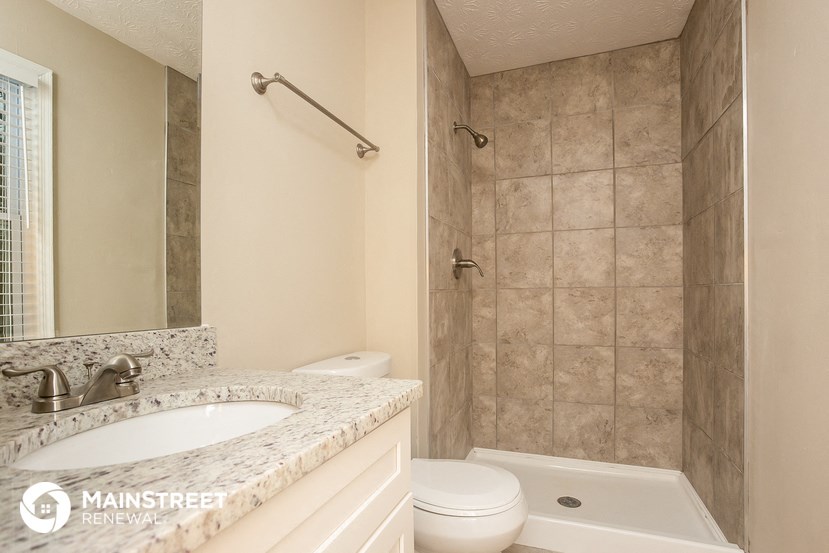 a bathroom with a sink toilet and a shower
