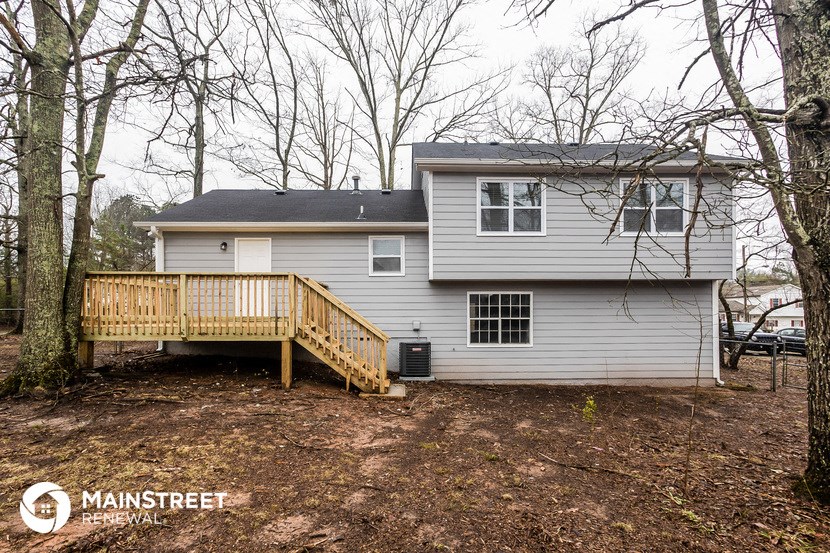 the back of a house with a porch and a deck