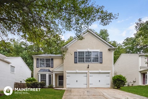 a beige house with a white garage door