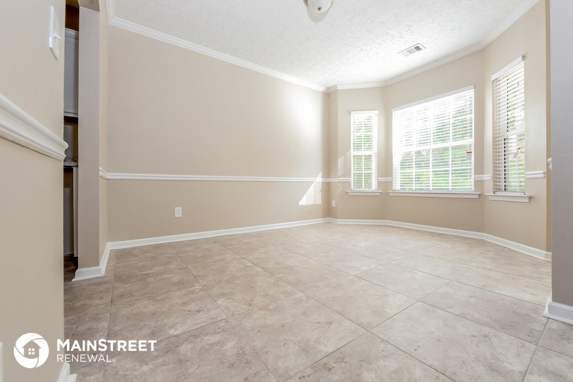 the dining room of this home has been remodeled and is empty