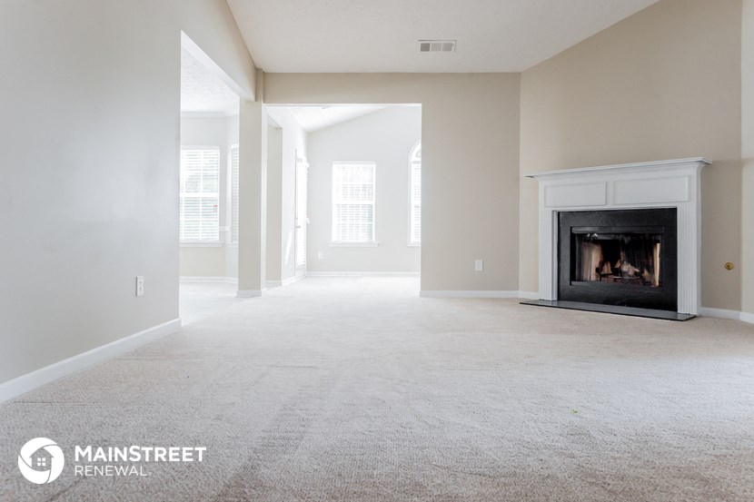the living room of a new home with a fireplace