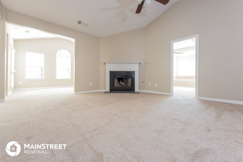the living room of a new home with a fireplace