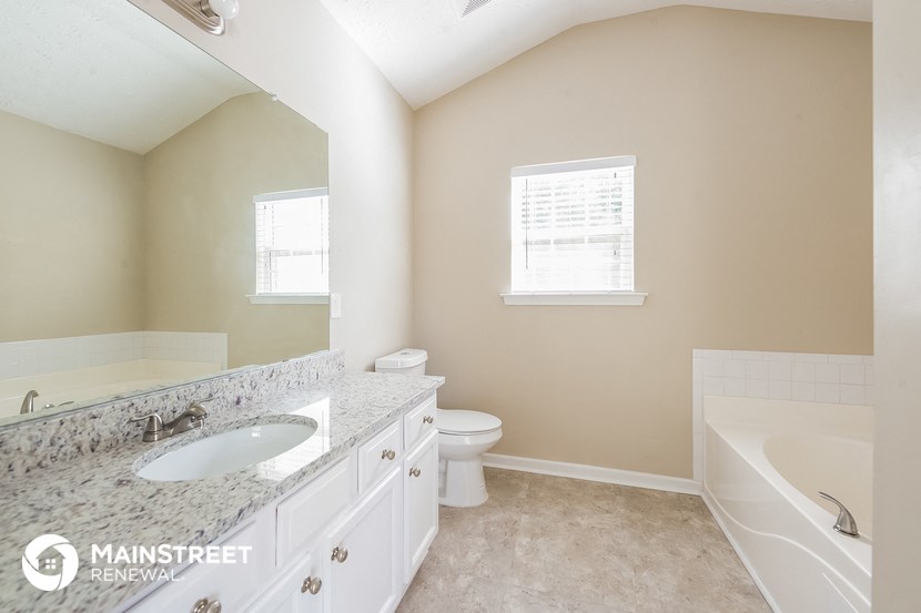 a bathroom with a sink and a toilet and a bath tub