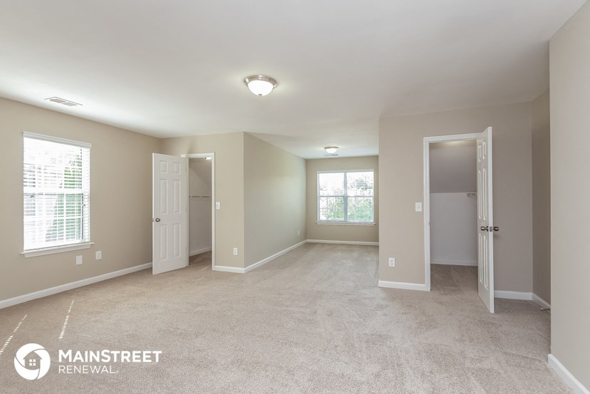 the master bedroom is spacious and updated with new carpeting and updated lighting