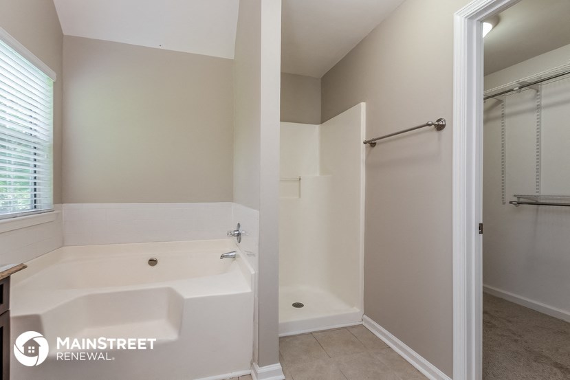 the master bathroom has a soaking tub and a walk in shower