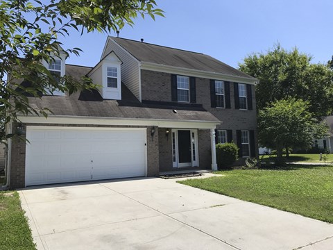 a house with a white garage door in front of it