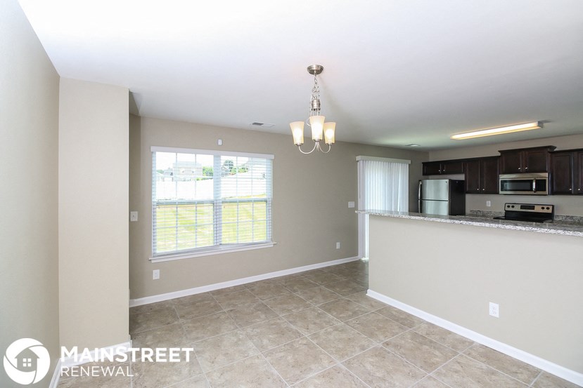 an empty kitchen with a large window and a counter top