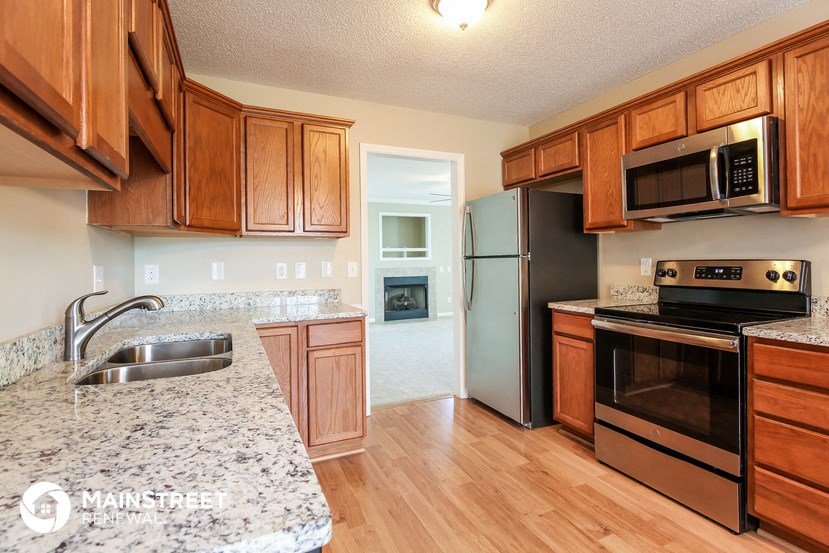 a kitchen with stainless steel appliances and granite counter tops