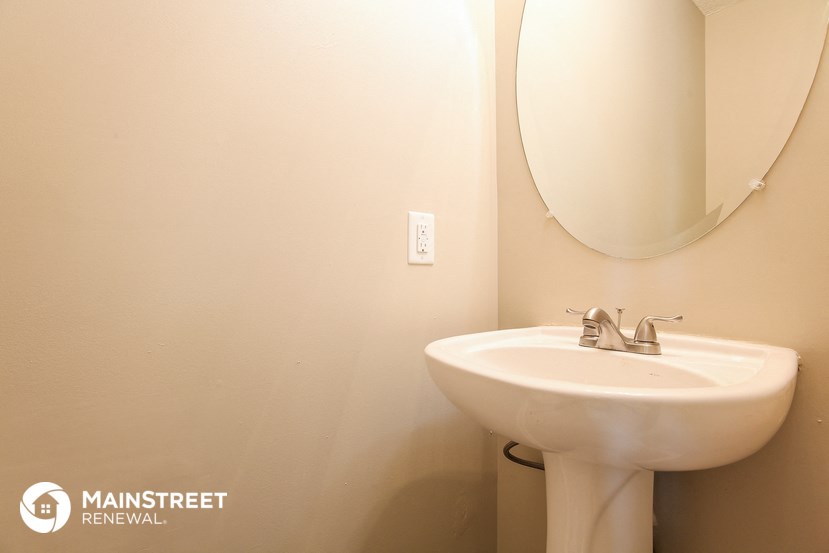 a small bathroom with a sink and a mirror