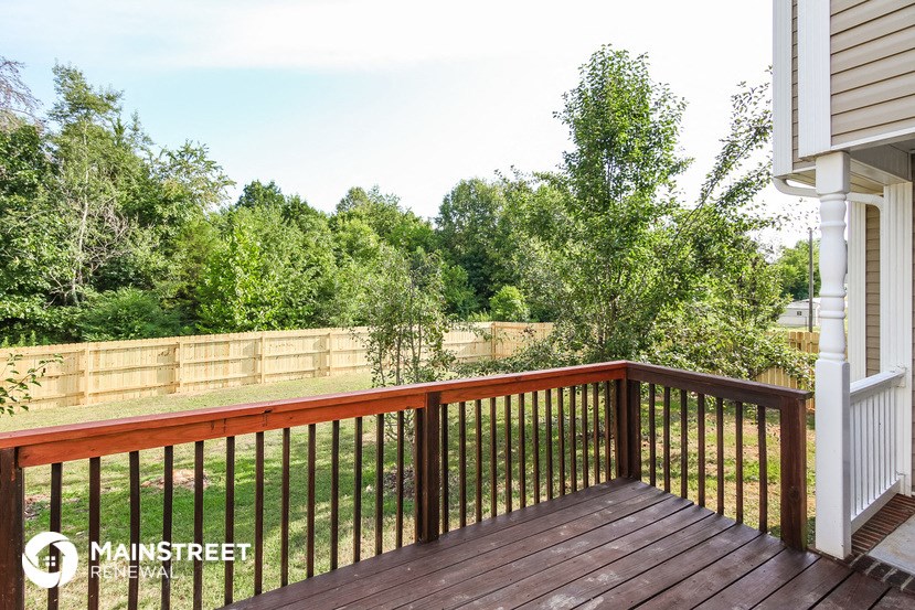the view from the deck of a backyard with trees