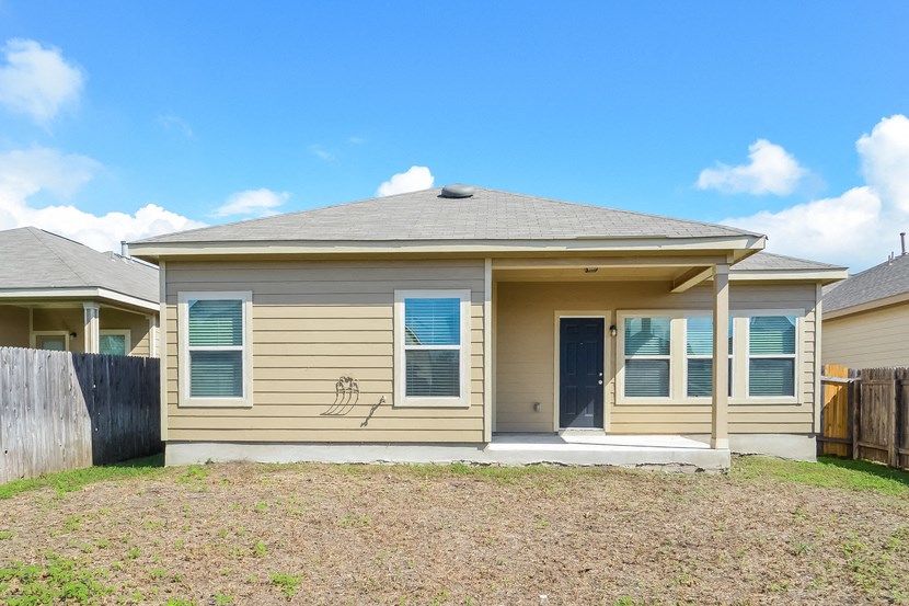 a yellow house with a yard in front of it