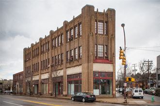 a large brick building on the corner of a city street