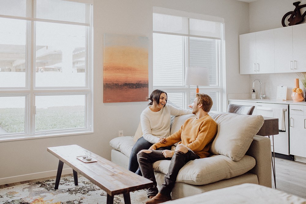 a couple sitting on a couch in a living room