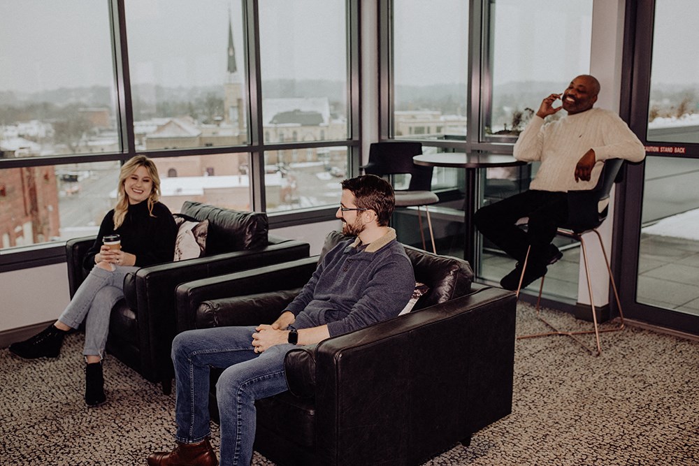 a group of people sitting in chairs in front of a window