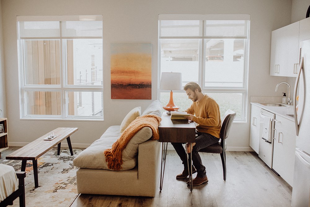 a man sitting at a table in a living room