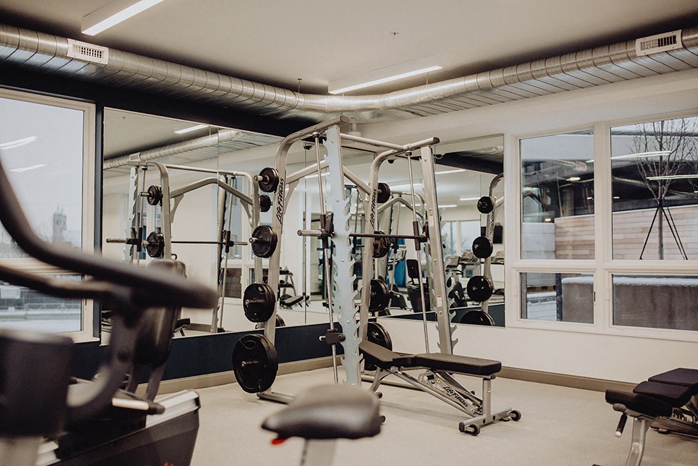 a gym with weights and other exercise equipment in a building