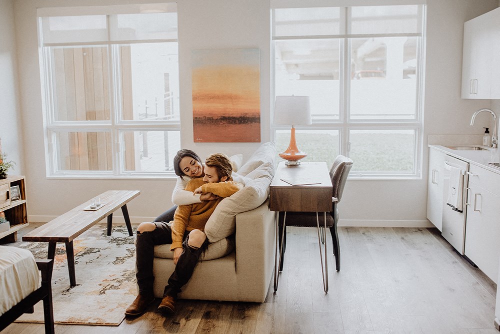 a couple sitting on a couch in a living room