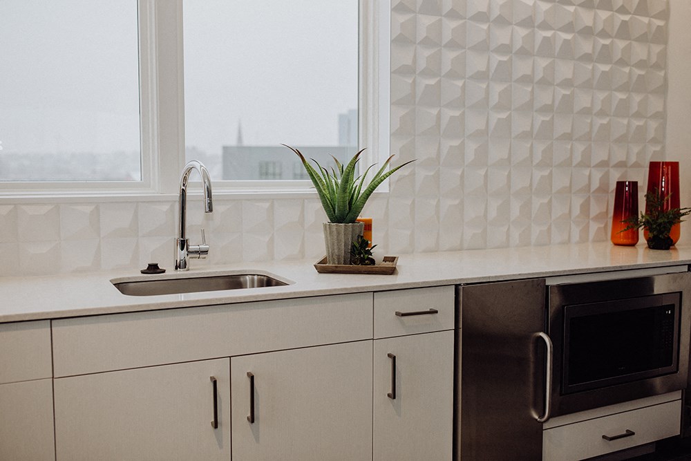 a kitchen counter with a sink and a window