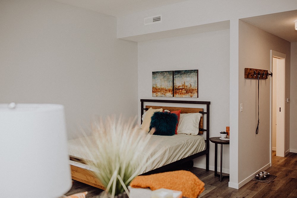 a bedroom with a bed and a table and a printer