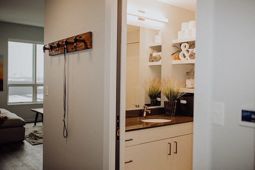 a bathroom with a sink and a refrigerator