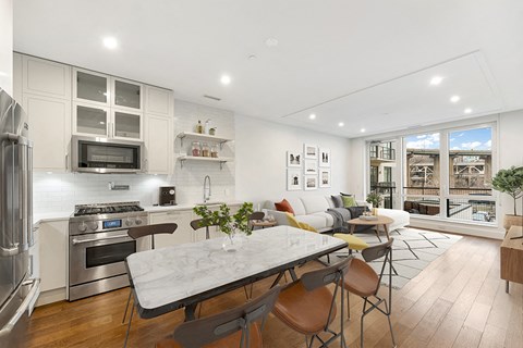 a living room with a kitchen and a dining table