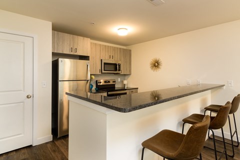 a kitchen with a counter top and a refrigerator