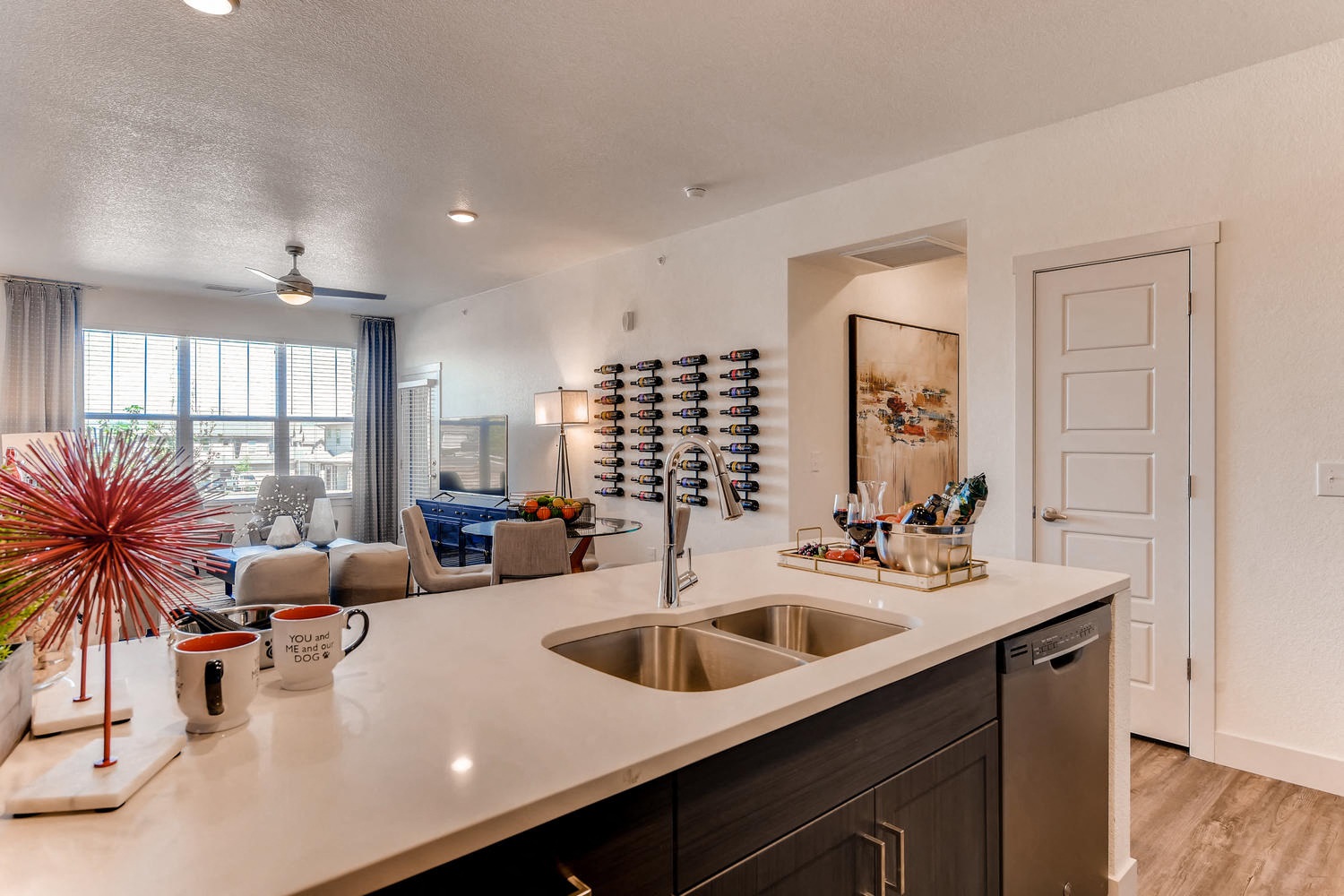 a kitchen with a sink and a window and a living room