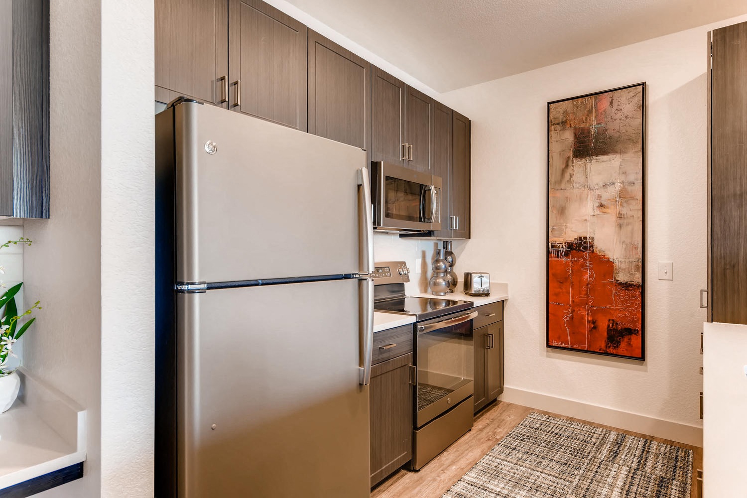 a kitchen with stainless steel appliances and a refrigerator