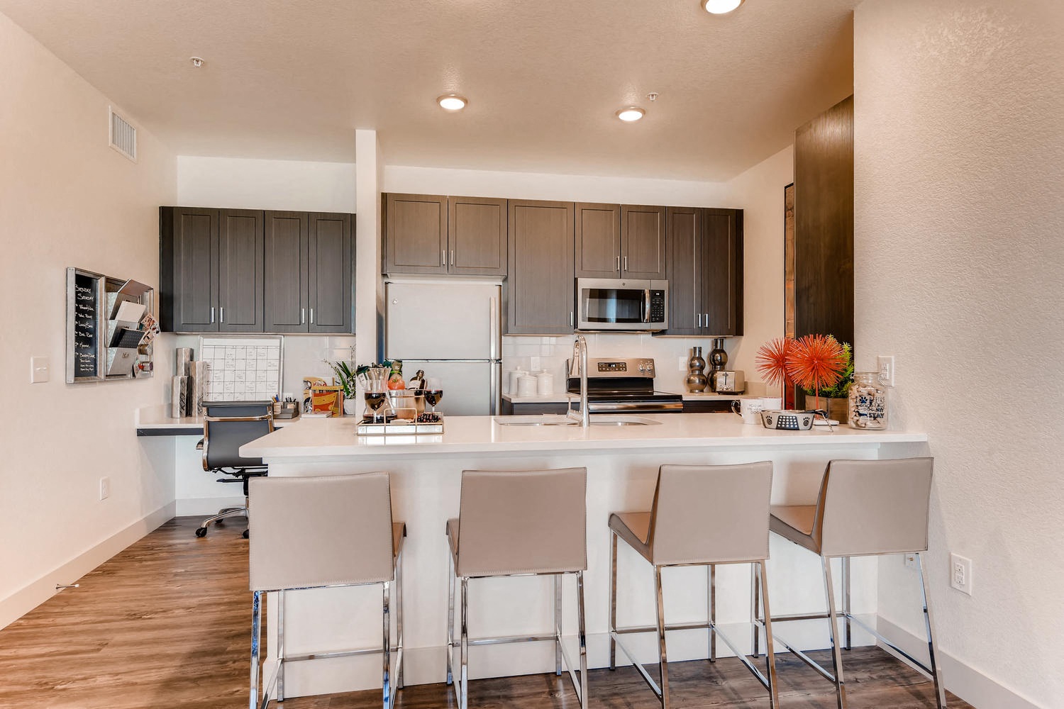 a kitchen with a large island with bar stools