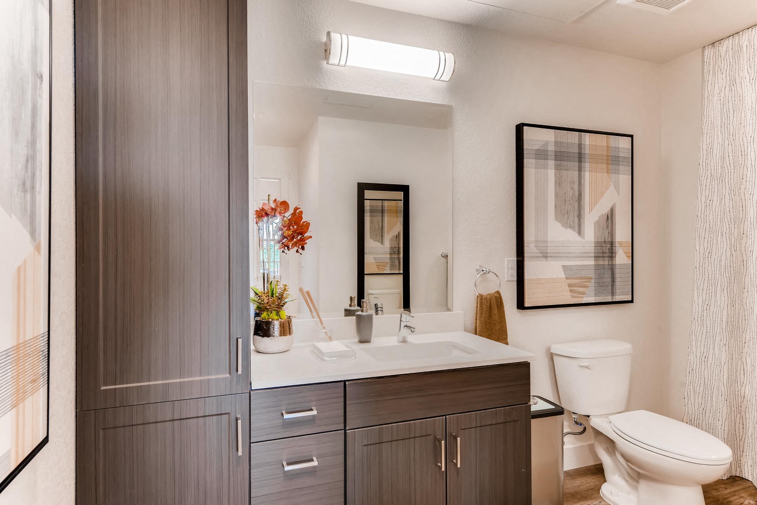 a bathroom with a sink and toilet and a mirror