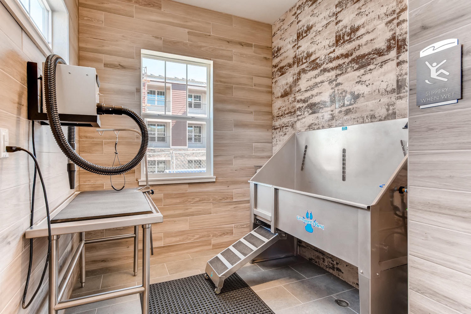 a utility room with a sink and a refrigerator and a chair