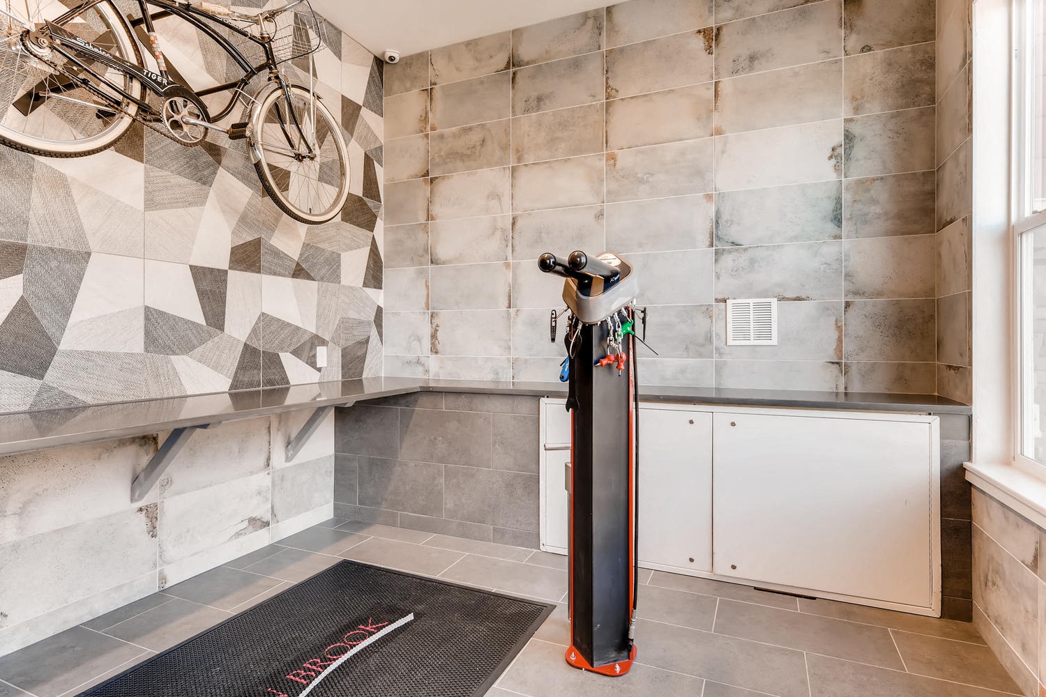 a gym with a bike hanging on the wall in the corner of a room