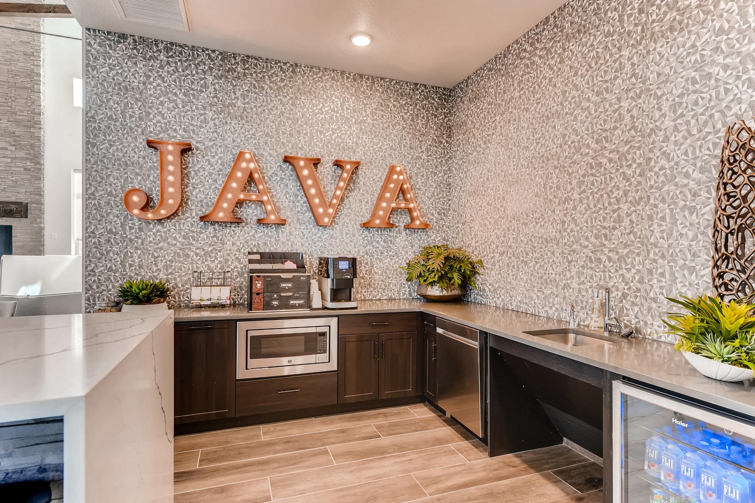 a kitchen with a counter and a sign on the wall