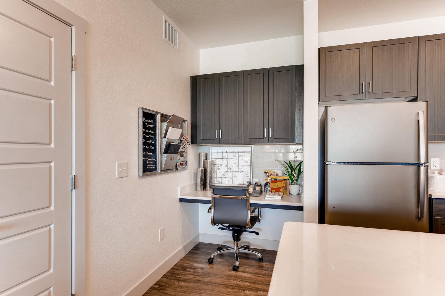 our apartments offer a kitchen with a desk and refrigerator