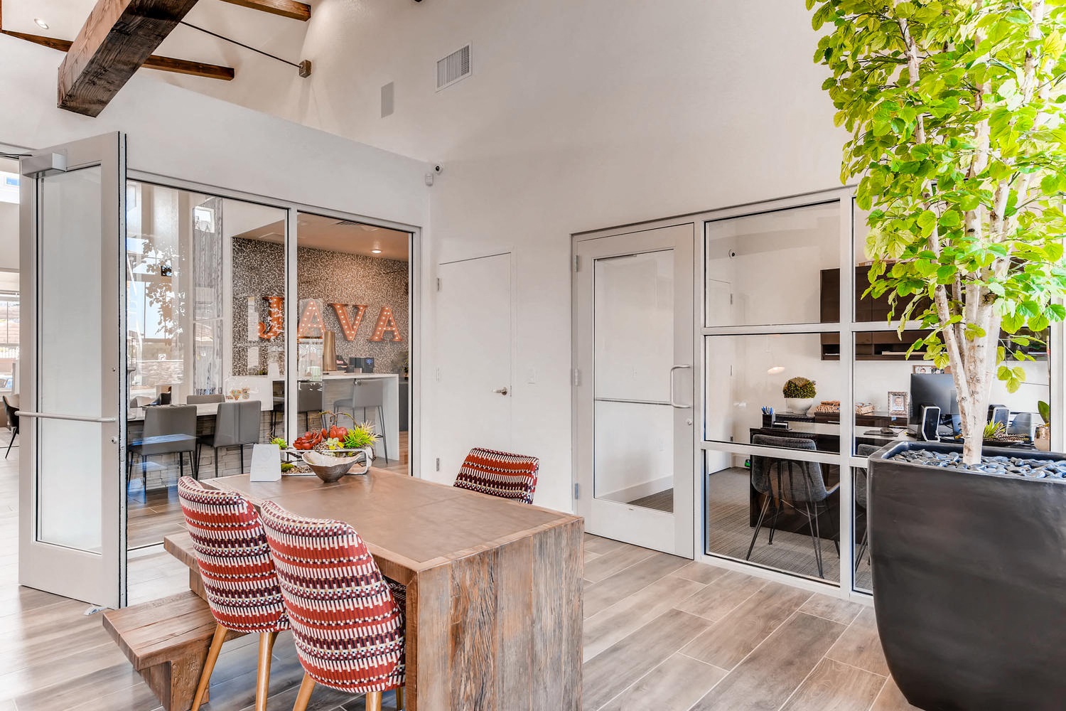 a dining area with a wooden table and chairs and sliding glass doors