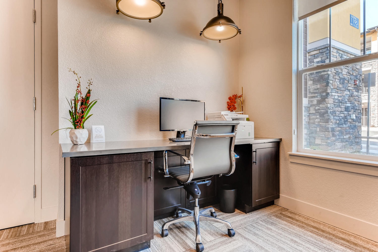 a home office with a desk and a window